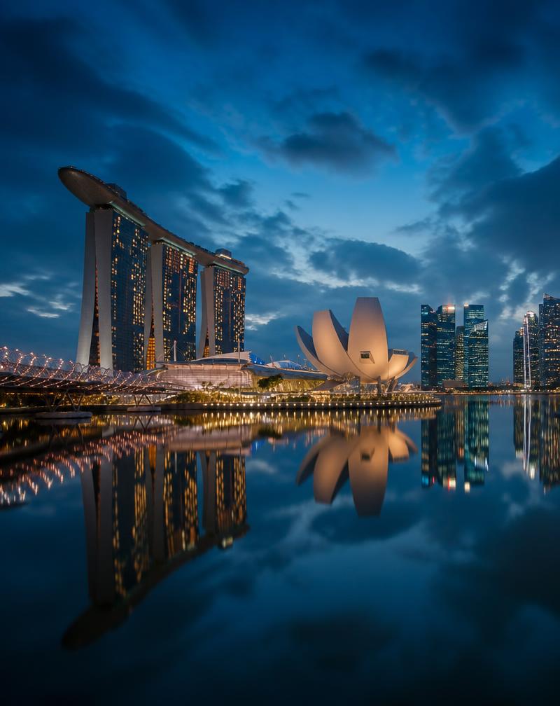 City skyline reflected in still water at blue hour